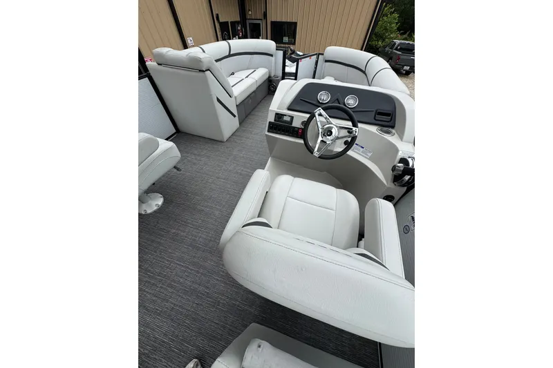 Slide: The Image of 2023 Crest 220 Classic LX boat interior with plush seating and modern dashboard. - 6