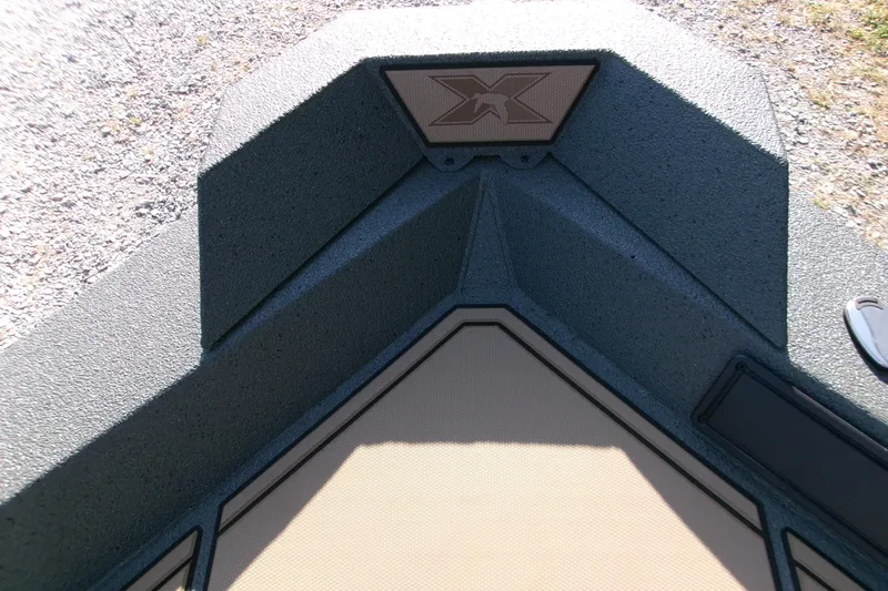 Slide: The Image of Bow of 2027 Xpress X18DB boat with textured surface and logo. - 12