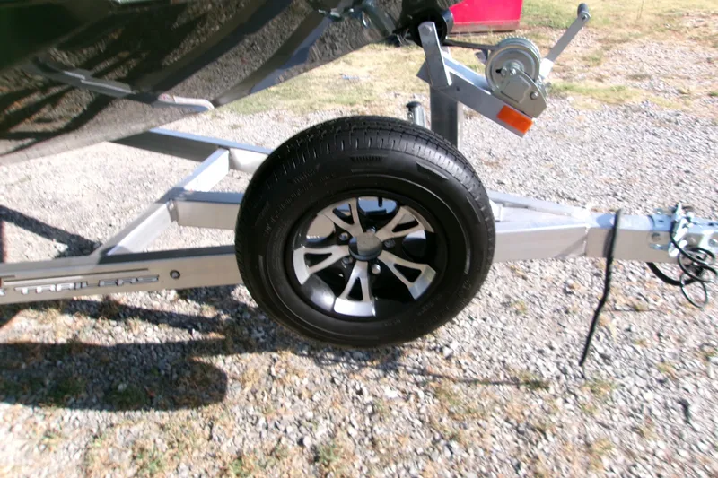 Slide: The Image of Trailer wheel of 2027 Xpress X18DB boat on gravel surface. - 5