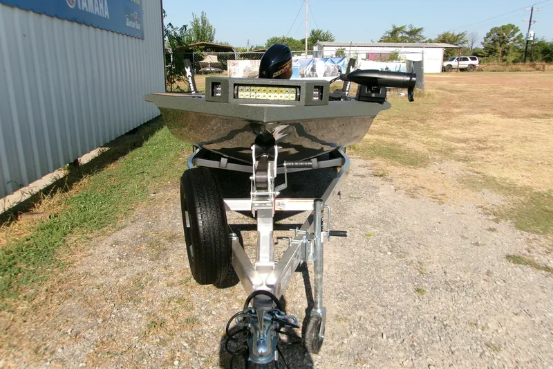 Slide: The Image of 2027 Xpress X18DB boat on trailer, parked outdoors near a Yamaha sign. - 2