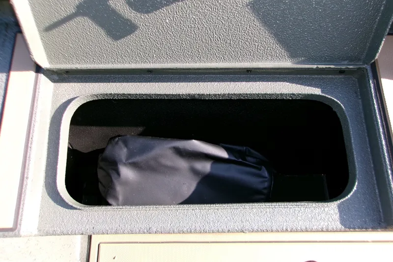 Slide: The Image of Open storage compartment in 2027 Xpress X18DB boat, containing a black bag. - 9