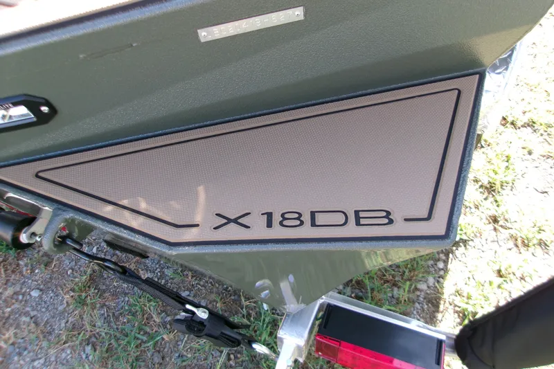 Slide: The Image of 2027 Xpress X18DB boat detail with model nameplate and textured panel. - 14