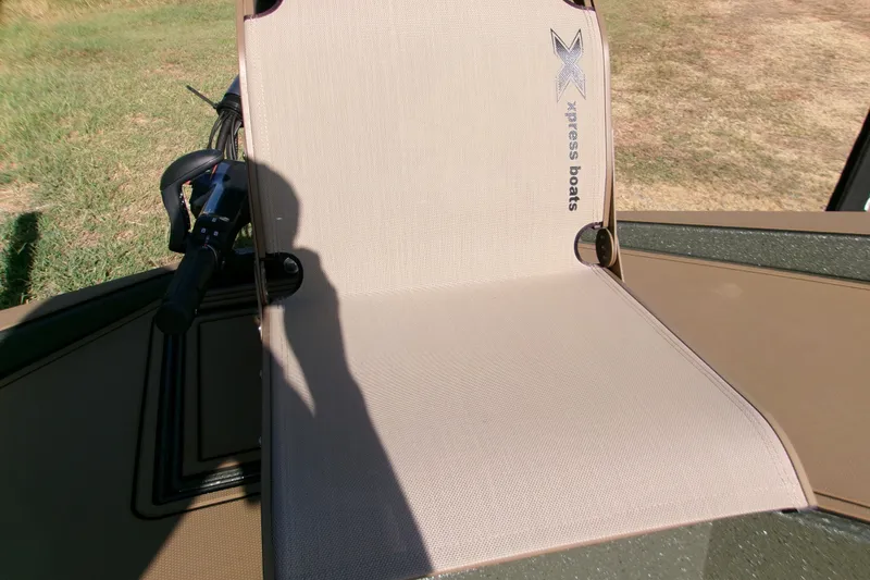 Slide: The Image of Xpress X18DB boat seat with logo, 2027 model, in outdoor setting. - 13