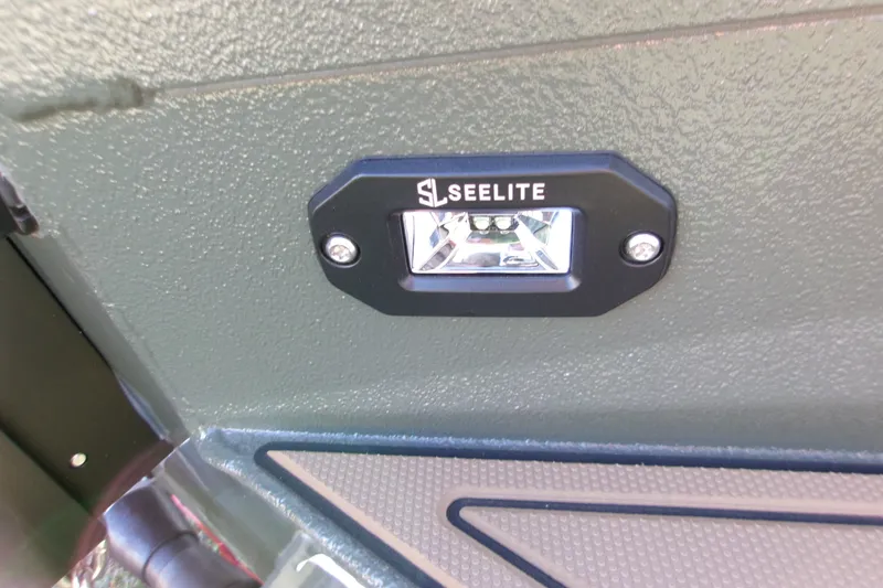 Slide: The Image of 2027 Xpress X18DB boat featuring a Seelite LED light on textured surface. - 17