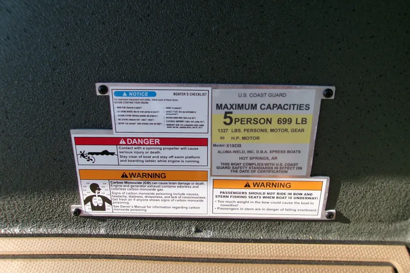 Slide: The Image of Boat capacity and safety warning labels for Xpress X18DB, 2027 model, detailing weight limits and hazards. - 4