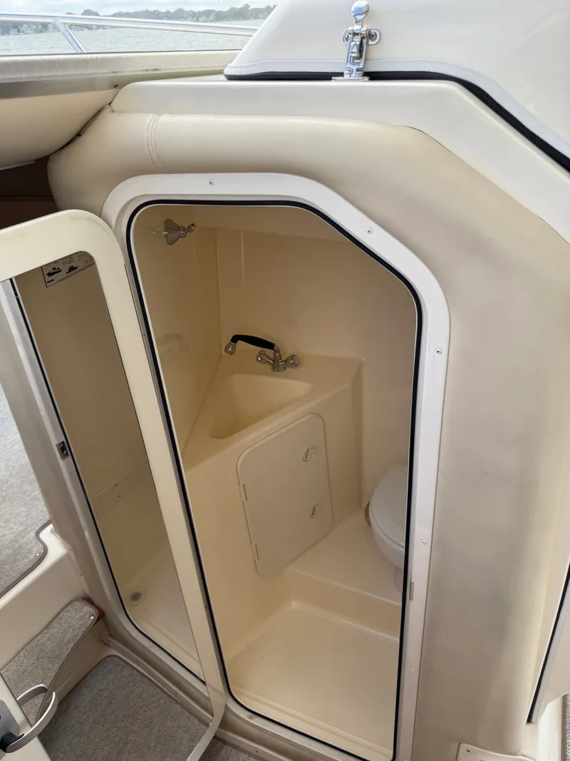 Slide: The Image of The image shows a small bathroom on a boat with a toilet and sink. - 5