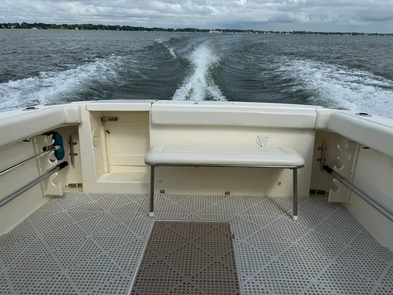Slide: The Image of The image shows the stern of a boat with a bench seat and a view of the water. - 1