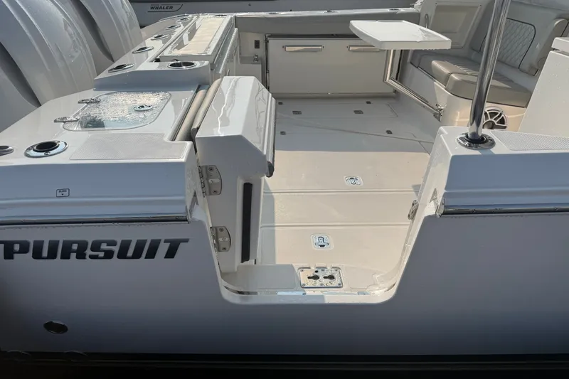 Slide: The Image of 2026 Pursuit DC 326 Dual Console boat interior with seating and storage. - 7