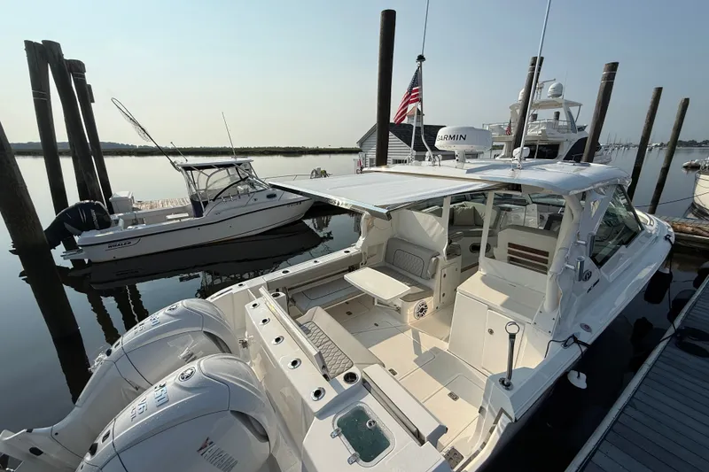 Slide: The Image of 2026 Pursuit DC 326 Dual Console boat docked with Yamaha engines. - 12