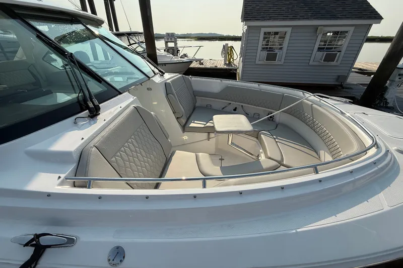 Slide: The Image of 2026 Pursuit DC 326 Dual Console boat with spacious seating and table on deck. - 4