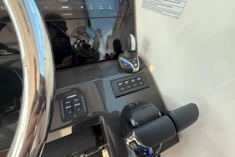 Slide: The Image of Control panel of 2026 Pursuit DC 326 Dual Console boat with steering and throttle. - 18