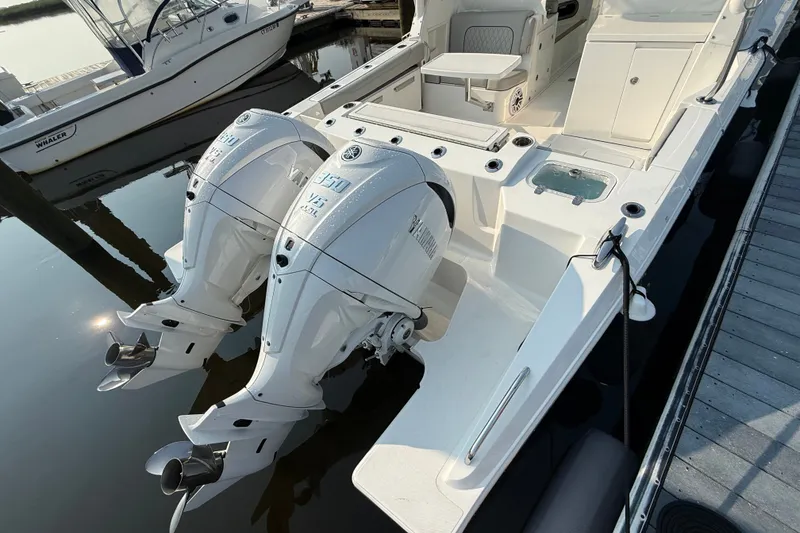 Slide: The Image of 2026 Pursuit DC 326 Dual Console with twin Yamaha outboard engines docked. - 19