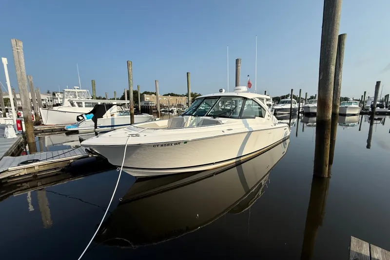 The Image of 2026 Pursuit DC 326 Dual Console boat docked in a marina. - 0