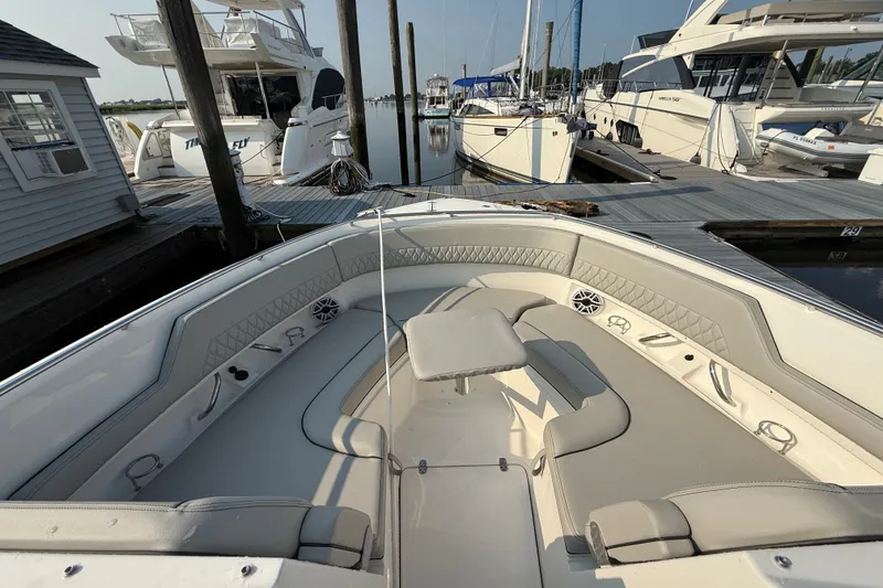 Slide: The Image of 2026 Pursuit DC 326 Dual Console boat docked at marina, featuring spacious seating area. - 10