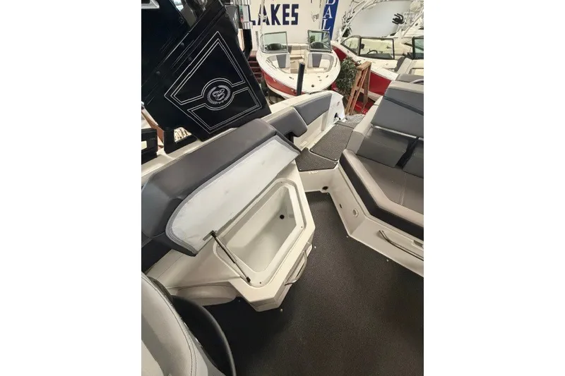 Slide: The Image of 2023 Cobalt R4 Surf boat interior with open storage compartment and seating. - 21