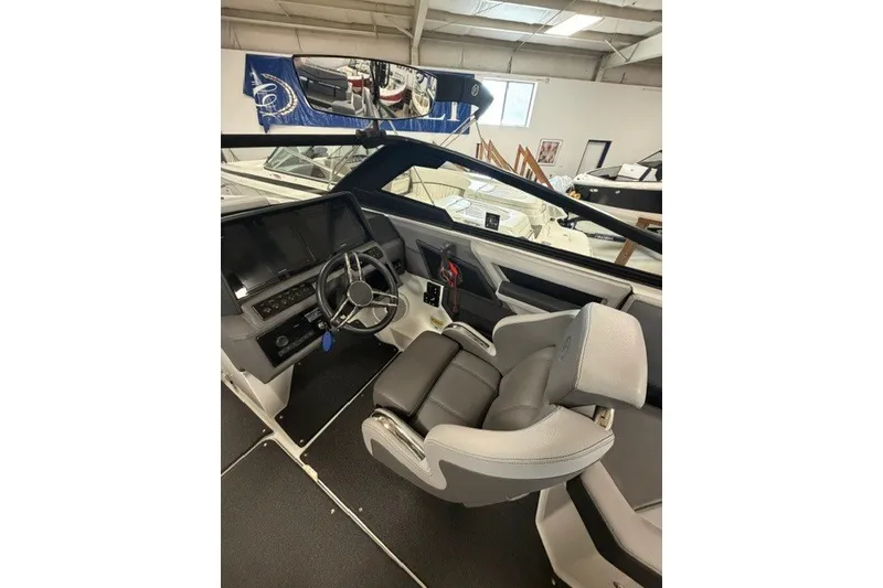 Slide: The Image of 2023 Cobalt R4 Surf boat interior with modern helm and comfortable seating. - 18