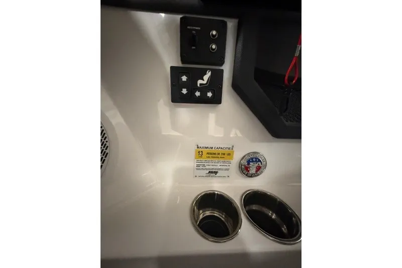 Slide: The Image of Control panel and capacity label on 2023 Cobalt R4 Surf boat interior. - 15