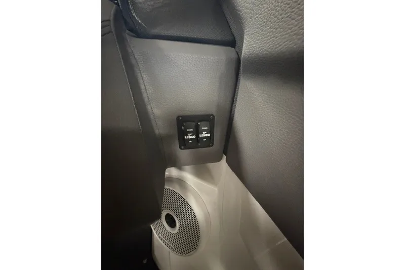 Slide: The Image of Interior of 2023 Cobalt R4 Surf boat featuring Lenco trim tab controls and speaker. - 16