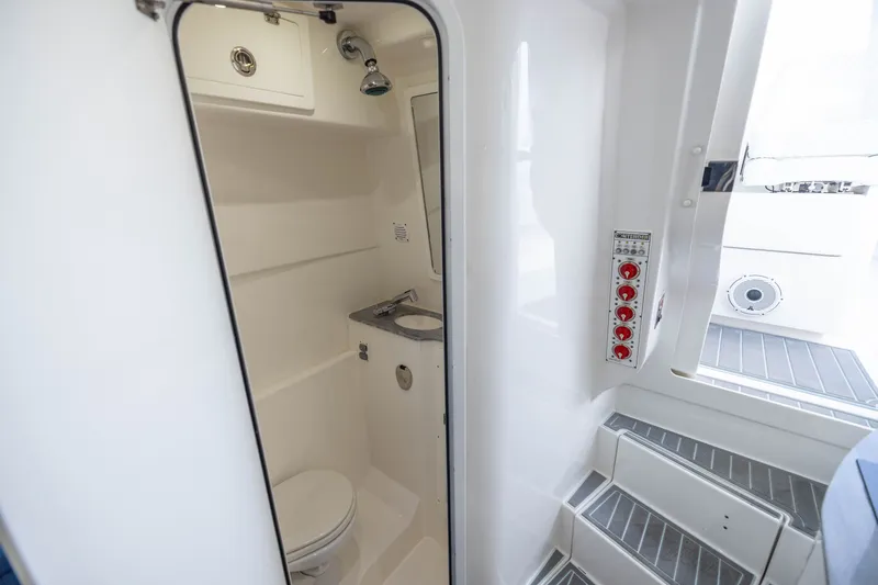 Slide: The Image of 2020 Contender 44 Fisharound boat interior with compact bathroom and control panel. - 48
