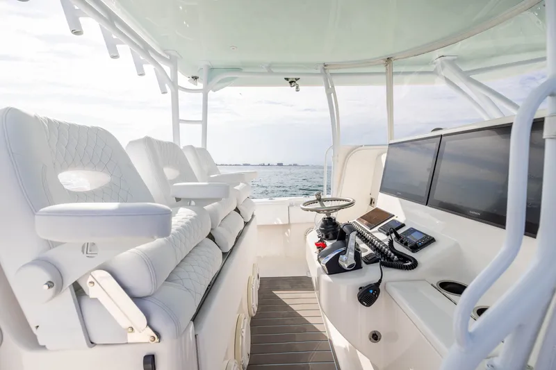 Slide: The Image of 2020 Contender 44 Fisharound boat cockpit with modern controls and seating. - 25