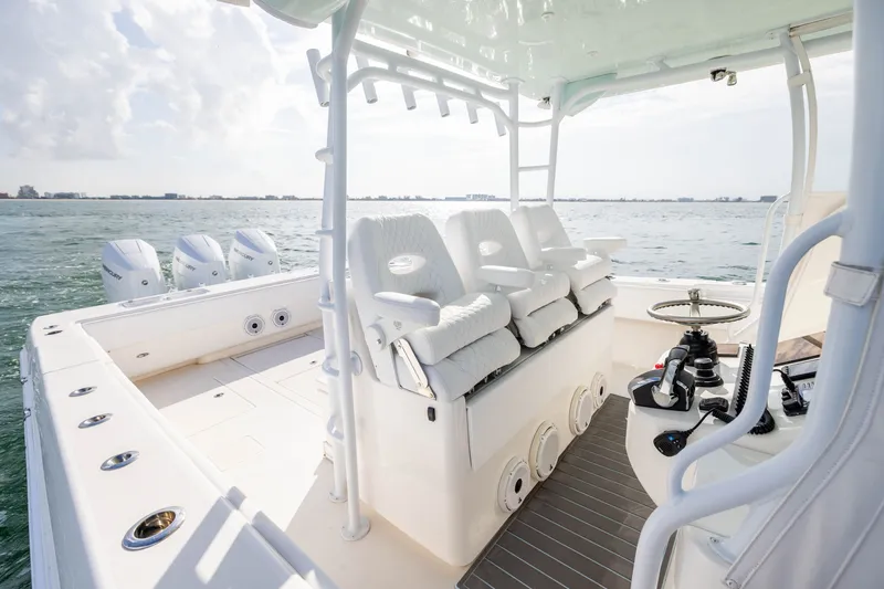 Slide: The Image of 2020 Contender 44 Fisharound boat interior with seating and controls, ocean view. - 22