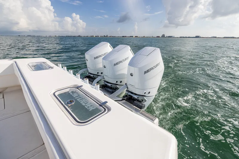 Slide: The Image of 2020 Contender 44 Fisharound with triple Mercury outboard engines on open water. - 38