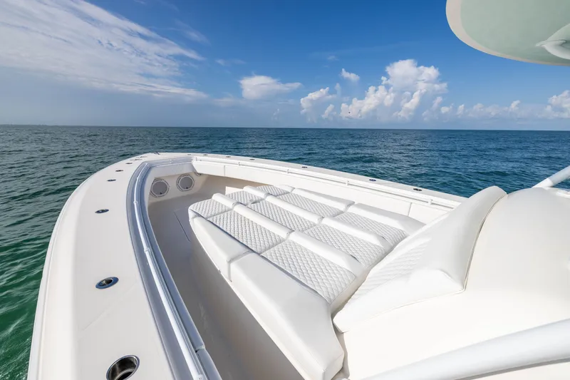 Slide: The Image of 2020 Contender 44 Fisharound boat with luxurious seating, ocean view, and clear blue sky. - 12