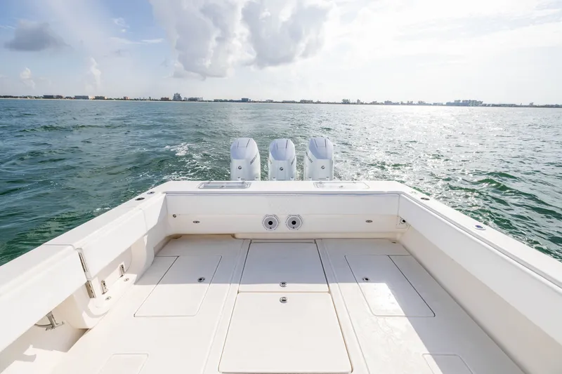 Slide: The Image of 2020 Contender 44 Fisharound boat on open water, featuring triple engines. - 35