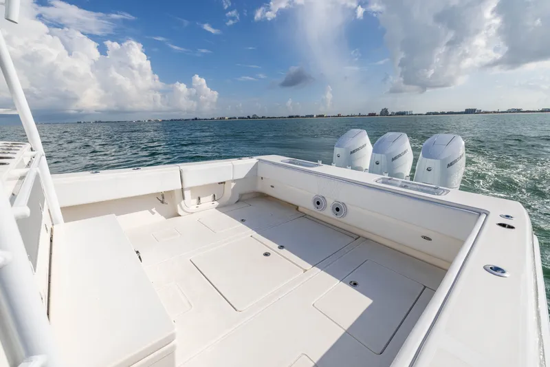 Slide: The Image of 2020 Contender 44 Fisharound boat deck with triple Mercury engines on open water. - 36