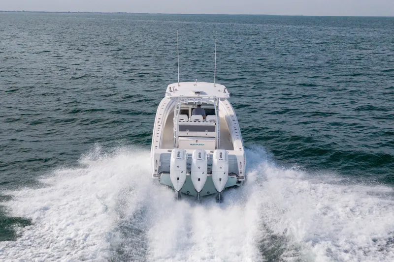 Slide: The Image of 2020 Contender 44 Fisharound boat cruising on open water, rear view. - 10