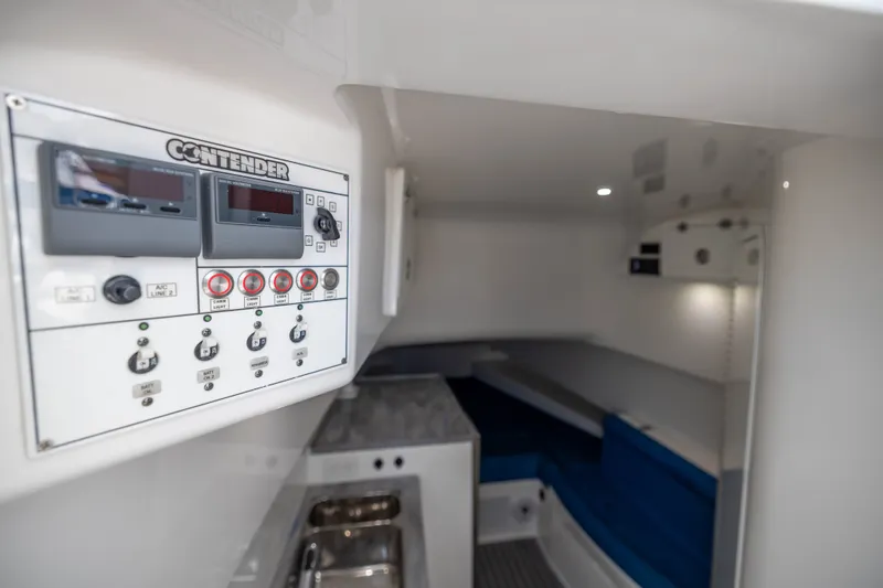 Slide: The Image of Interior of 2020 Contender 44 Fisharound boat, featuring control panel and cozy cabin space. - 44