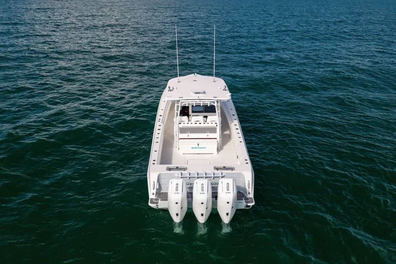 Slide: The Image of 2020 Contender 44 Fisharound boat with triple outboard engines on open water. - 5