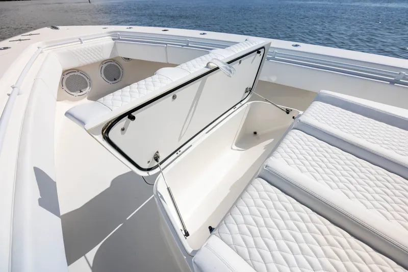 Slide: The Image of 2020 Contender 44 Fisharound boat with open storage compartment and quilted seating. - 19