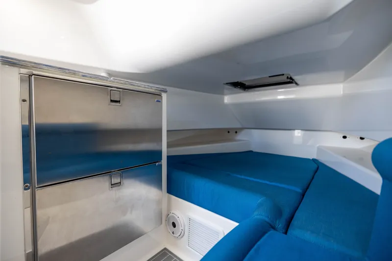 Slide: The Image of 2020 Contender 44 Fisharound cabin with blue seating and stainless steel storage. - 46