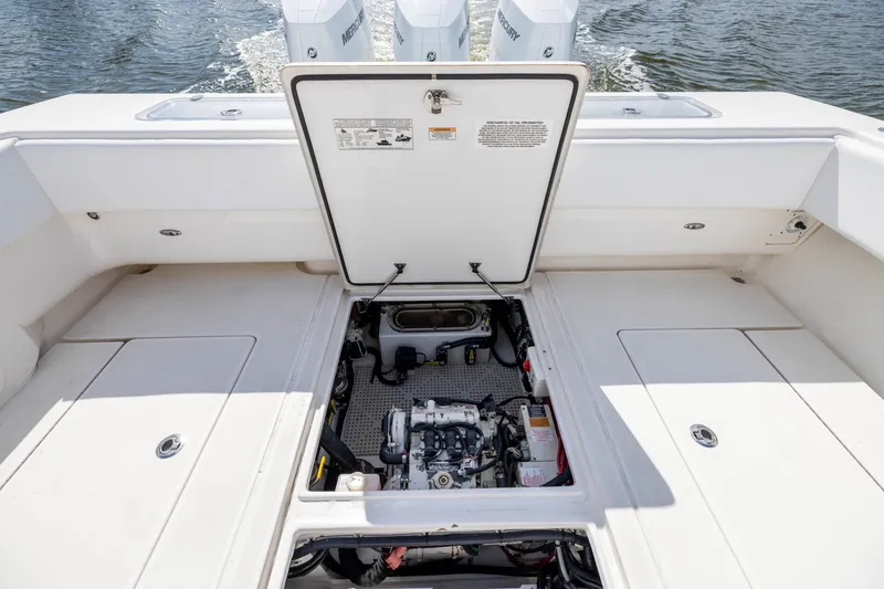 Slide: The Image of 2020 Contender 44 Fisharound boat engine compartment with open hatch, showing detailed interior. - 41
