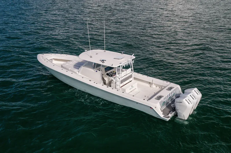 Slide: The Image of 2020 Contender 44 Fisharound boat on open water, featuring triple outboard engines. - 4