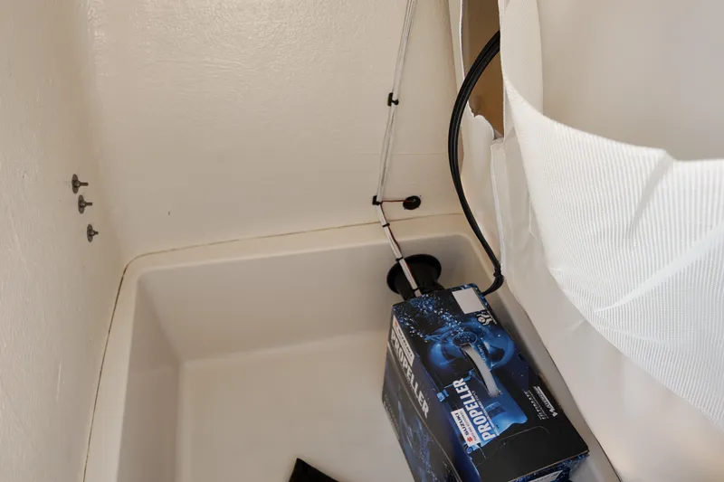 Slide: The Image of Storage compartment in 2027 Bulls Bay 200 Center Console with propeller box and fishing rod. - 14