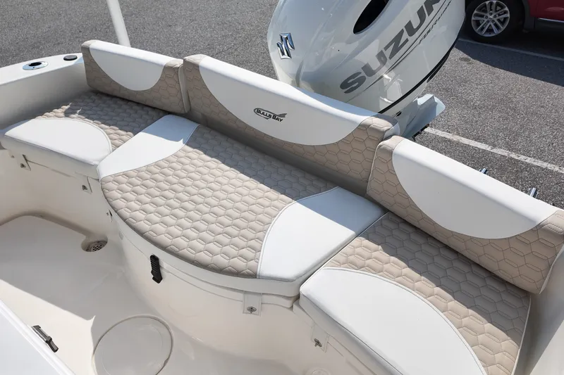 Slide: The Image of 2027 Bulls Bay 200 Center Console boat with Suzuki engine, featuring beige and white seating. - 6
