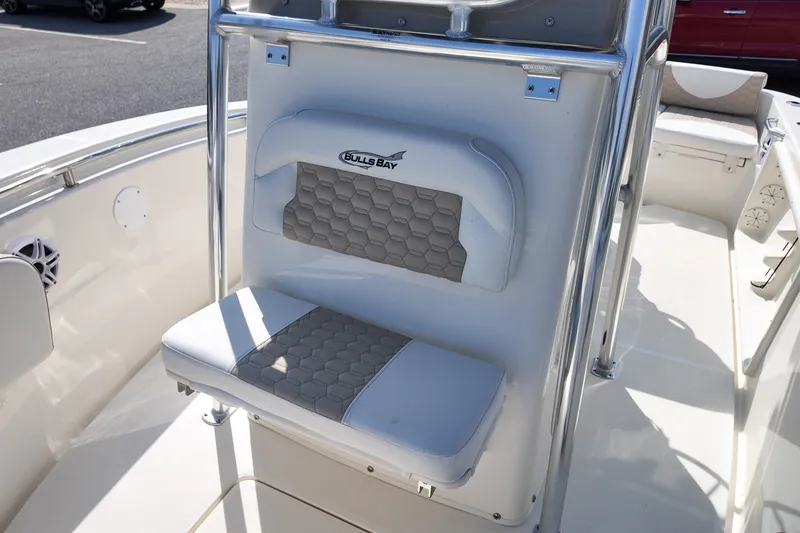 Slide: The Image of 2027 Bulls Bay 200 Center Console boat interior with cushioned seating and stainless steel railing. - 10