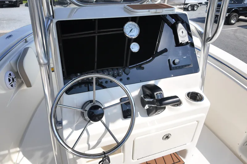 Slide: The Image of 2027 Bulls Bay 200 Center Console boat dashboard with steering wheel and controls. - 9