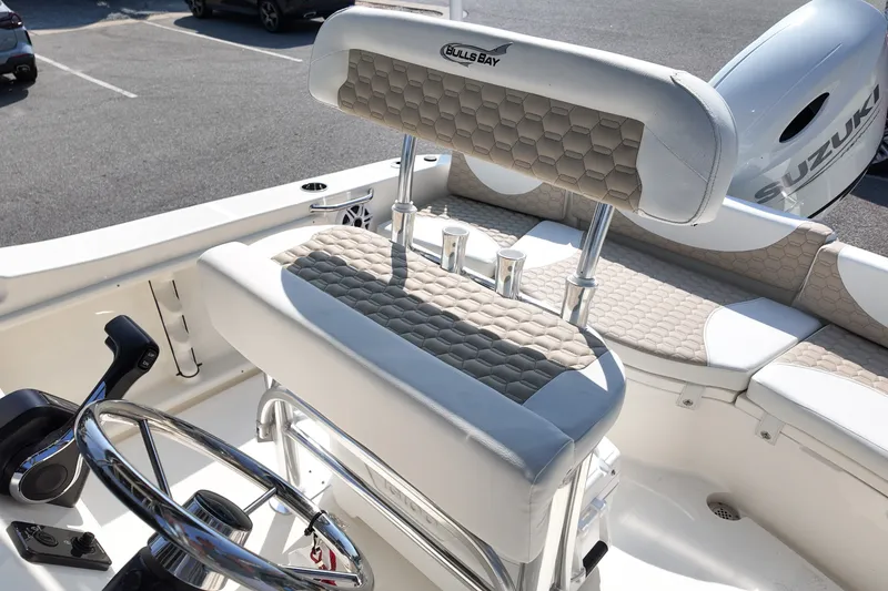 Slide: The Image of 2027 Bulls Bay 200 Center Console boat interior with steering wheel and seating. - 8
