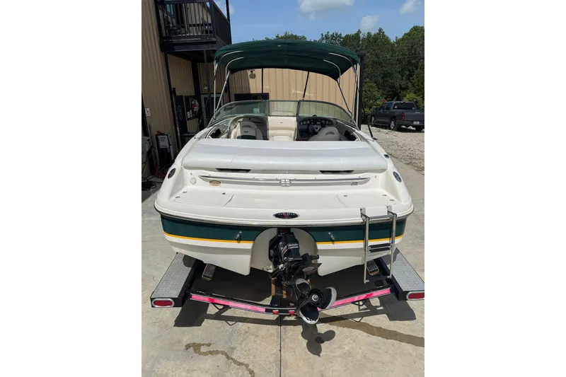 Slide: The Image of Rear view of a 2000 Chaparral 216 SSi boat on a trailer, parked outdoors. - 25