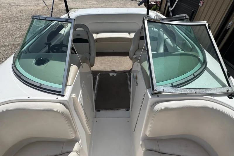 Slide: The Image of Interior view of a 2000 Chaparral 216 SSi boat with seating and windshield. - 16