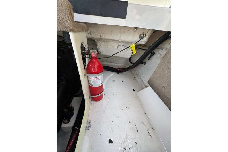 Slide: The Image of Fire extinguisher in 2000 Chaparral 216 SSi boat interior, near engine compartment. - 21