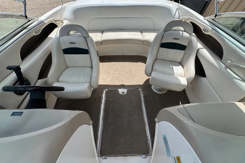 Slide: The Image of Interior of a 2000 Chaparral 216 SSi boat with white seating and steering wheel. - 17