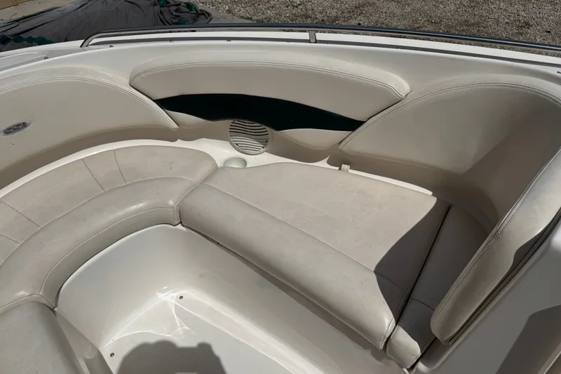 Slide: The Image of Interior seating of a 2000 Chaparral 216 SSi boat, featuring white cushioned seats. - 15