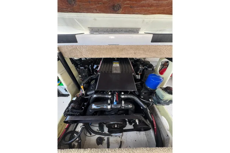 Slide: The Image of Engine compartment of a 2000 Chaparral 216 SSi boat, showcasing detailed components. - 19