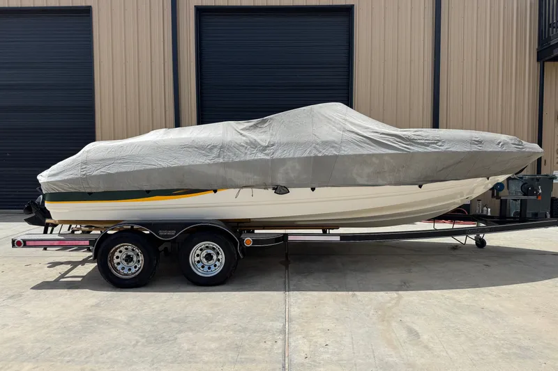 Slide: The Image of Covered 2000 Chaparral 216 SSi boat on trailer, parked outside a warehouse. - 22