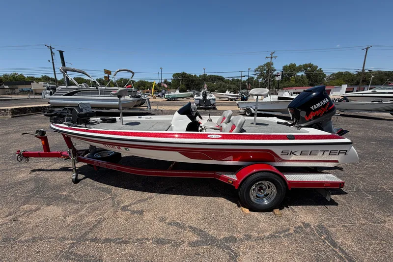 Slide: The Image of 2008 Skeeter SX190 boat with Yamaha engine on a trailer in a parking lot. - 5