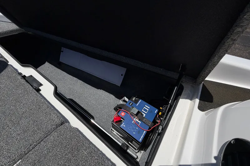 Slide: The Image of 2008 Skeeter SX190 boat battery compartment with wiring and storage space. - 24